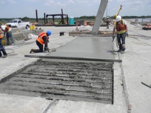 Precon Marine team members placing and smoothing concrete for dock repairs