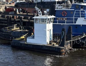 ALI-M (1) precon marine tugboat named Ali M docked by the water with another tugboat named Ida M by it's side