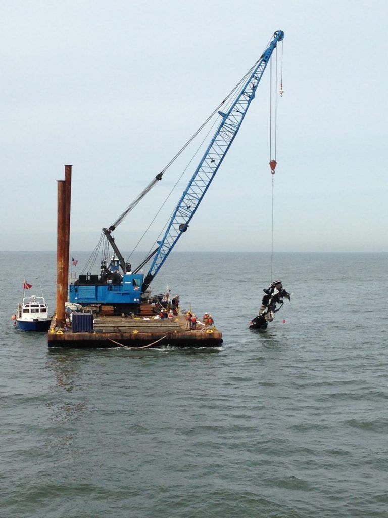floating barge crane collecting debris from the Chesapeake river