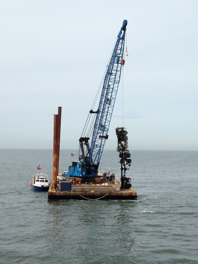crane on a barge collecting car debris from the Chesapeake river