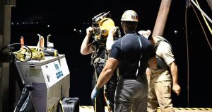 diver and Precon Marine crew members preparing for night construction