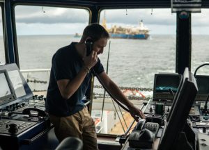 precone marine technician inspecting monitor to view R.O.V . inspection