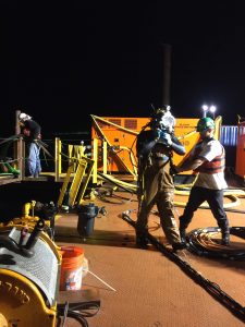 diver preparing scuba suit at night