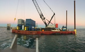 precon marine barge preparing to moor at a dock