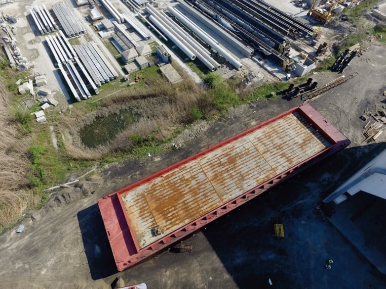 Sue-P-1-1 out of water barge being prepared for maintenance