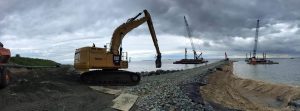 Precon Marine crane installing riprap on a shoreline