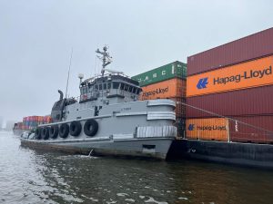Precon Marine Tugboat moving shipping containers on a barge over the Chesapeake river