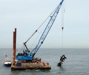 crane on barge collecting debris for rental
